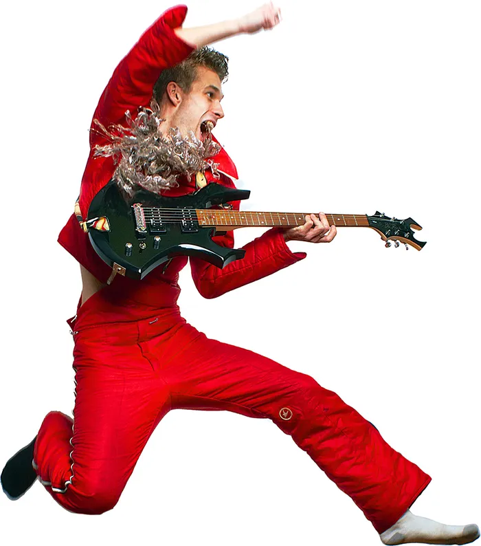 Aiden Abram mid-leap in a red suit, playing an electric guitar